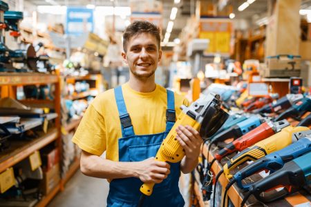 Builder choosing angle grinder in hardware store
